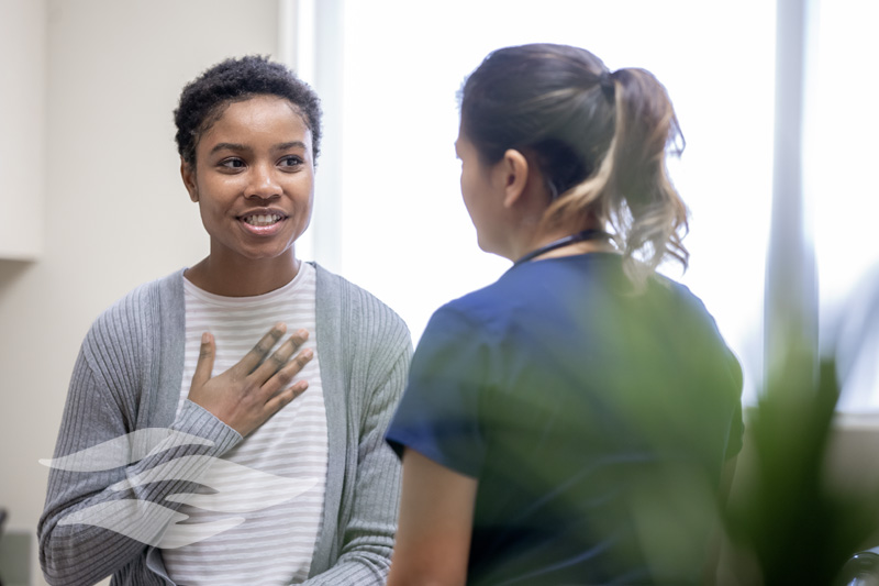 Nurse explaining good news to female patient