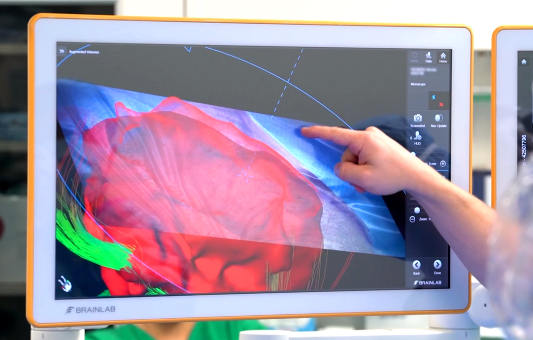 A nurse gestures towards the AR visualization.