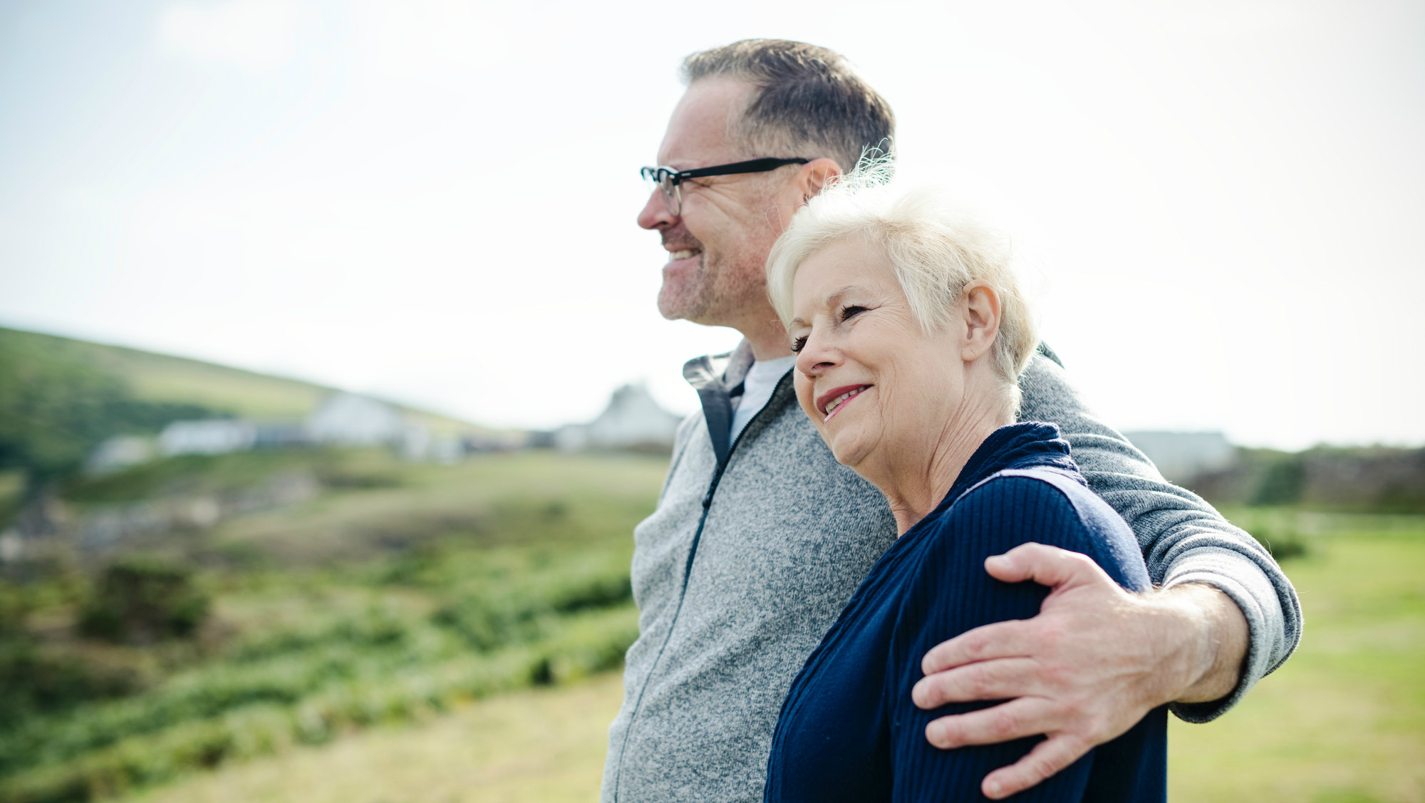 Older man and woman standing outside