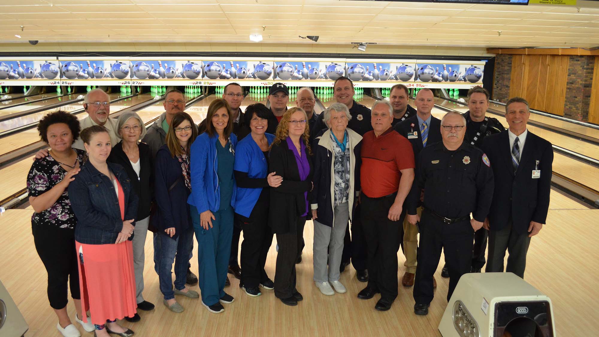 group photo in front of bowling alley lane