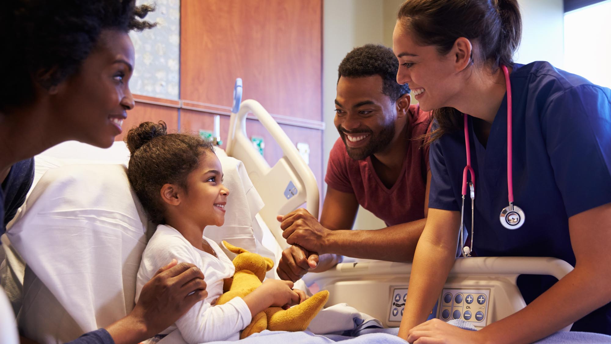 pediatrician and nurse with child patient and mother